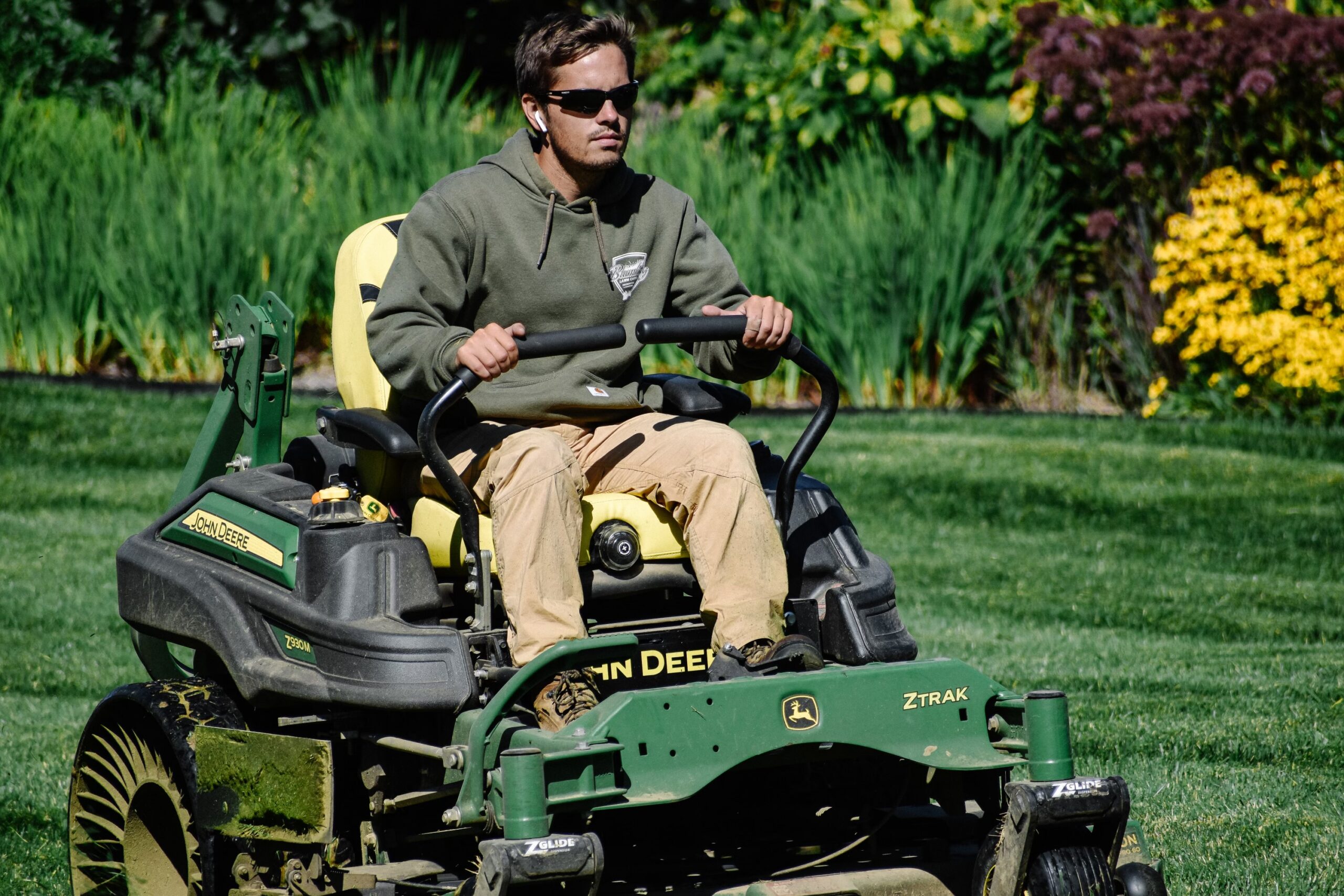 Man driving a riding lawn mower