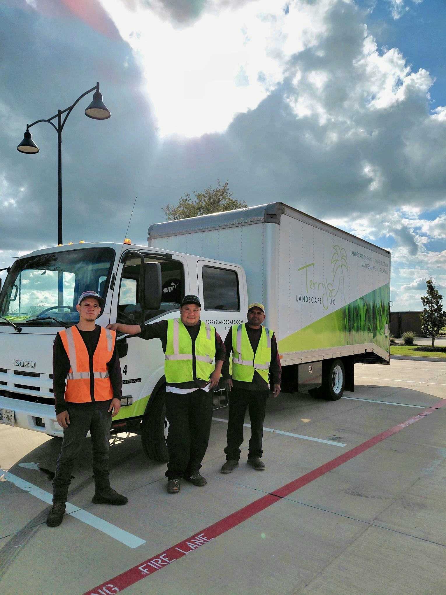 Three landscapers from Terry’s Landscape standing in front of a truck.