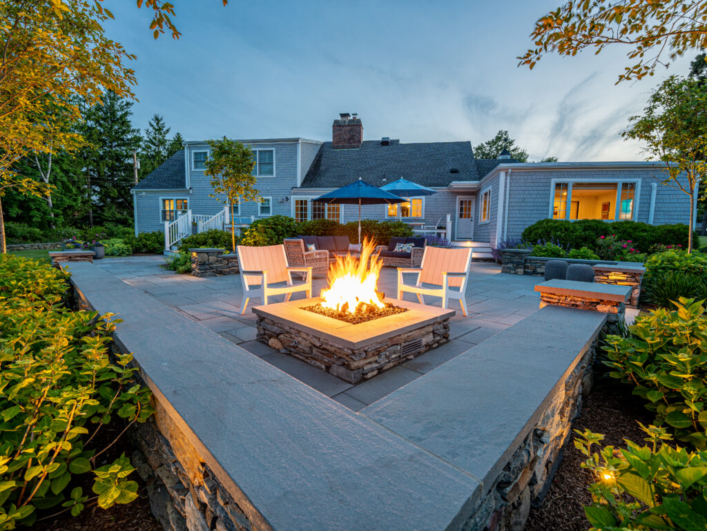Beautiful backyard with custom hardscape and landscape, including a firepit