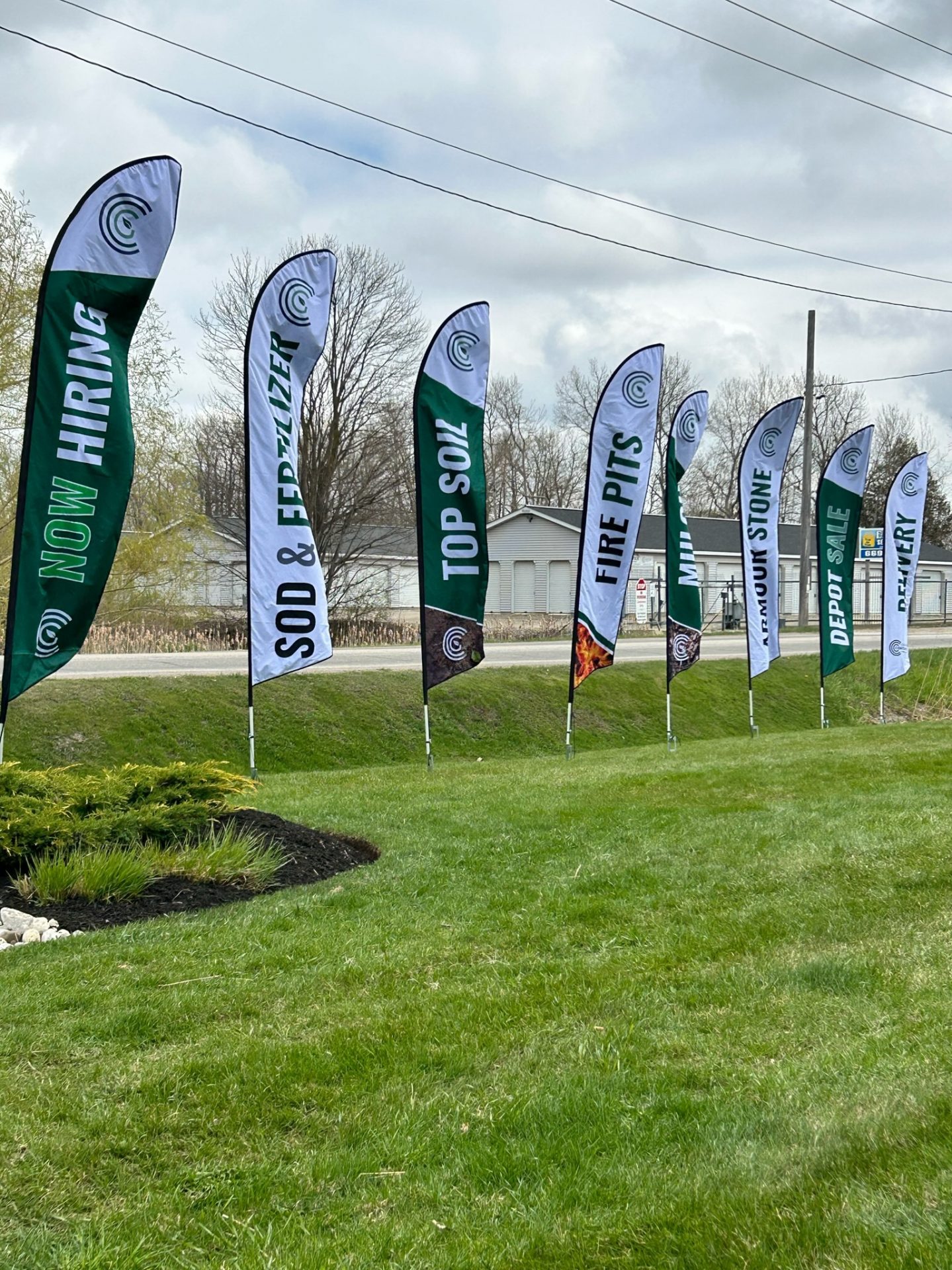 Mowed lawn with lawn flags advertising landscaping services